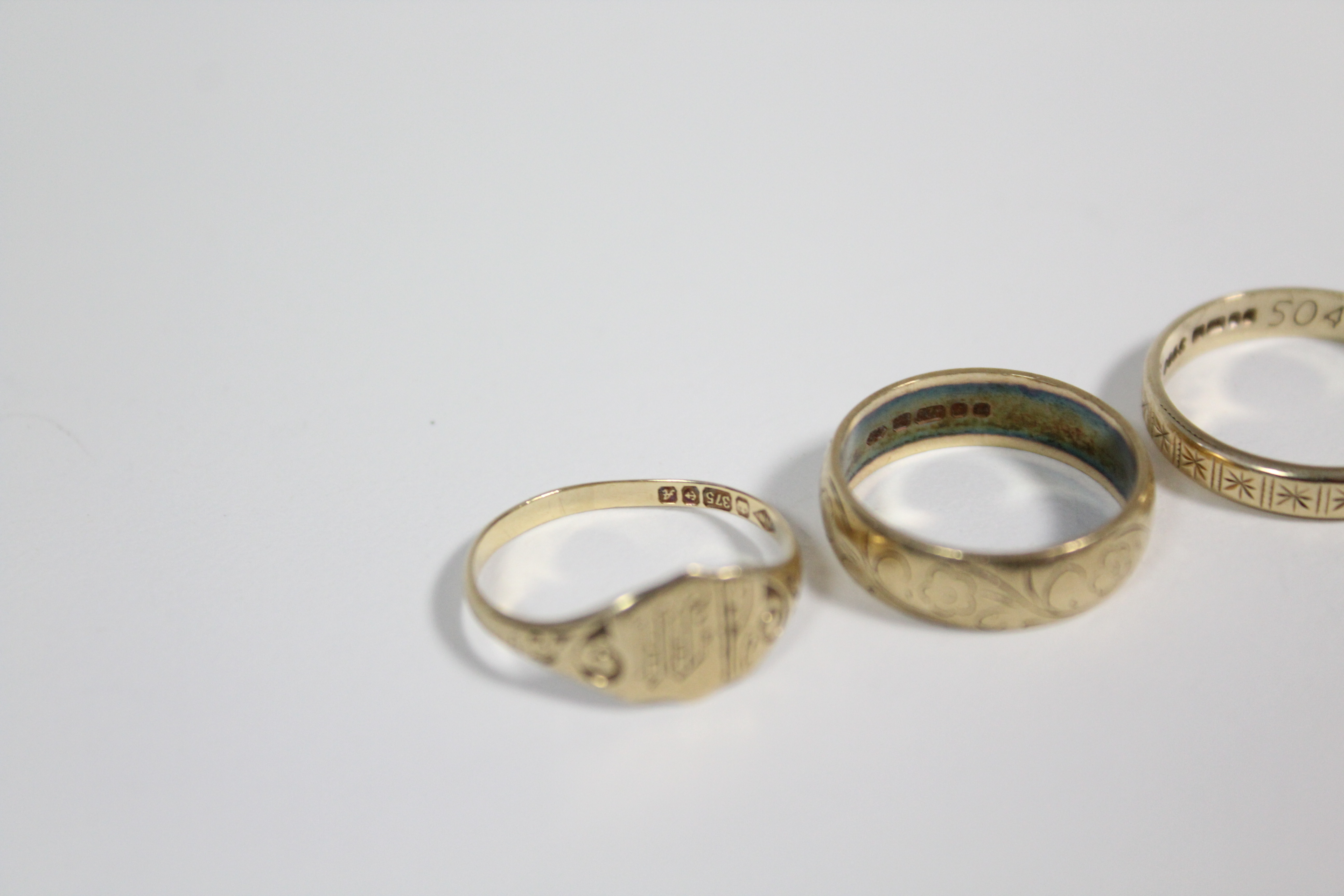 A 9ct. gold engraved belt buckle ring; a 9ct. engraved signet ring; two ditto engraved bands; a - Image 3 of 3