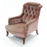 A Victorian armchair, the square buttoned-back, arms, & sprung seat upholstered salmon-pink