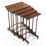 A nest of four regency-style mahogany occasional tables, the rectangular tops on turned spindle