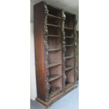 A Victorian oak tall standing open bookcase fitted fourteen adjustable shelves, and heavily carved