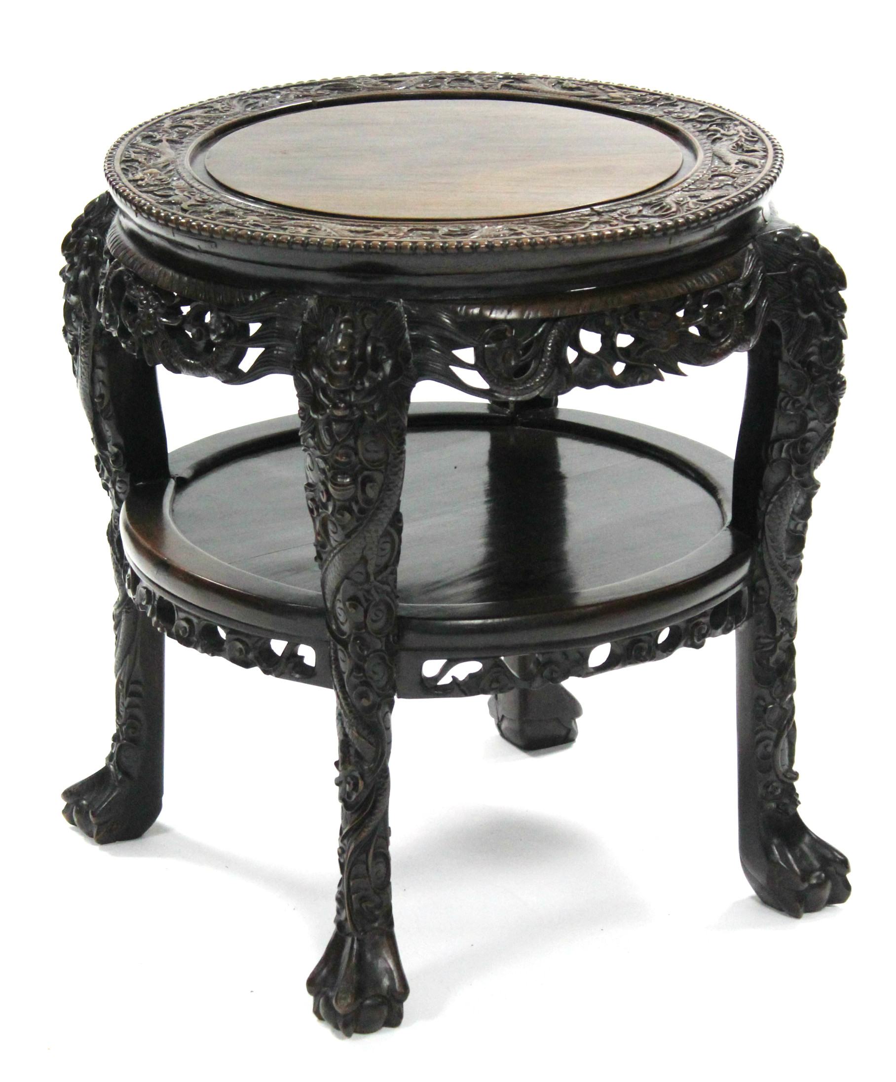 A late 19th century Chinese hardwood circular occasional table, profusely carved all-over with