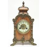 A late 19th century German rococo-style mantel clock, the 4” white enamel dial with Arabic numerals,