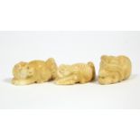 A Japanese carved ivory netsuke in the form of a tiger & a monkey; another of a goat & a monkey; &