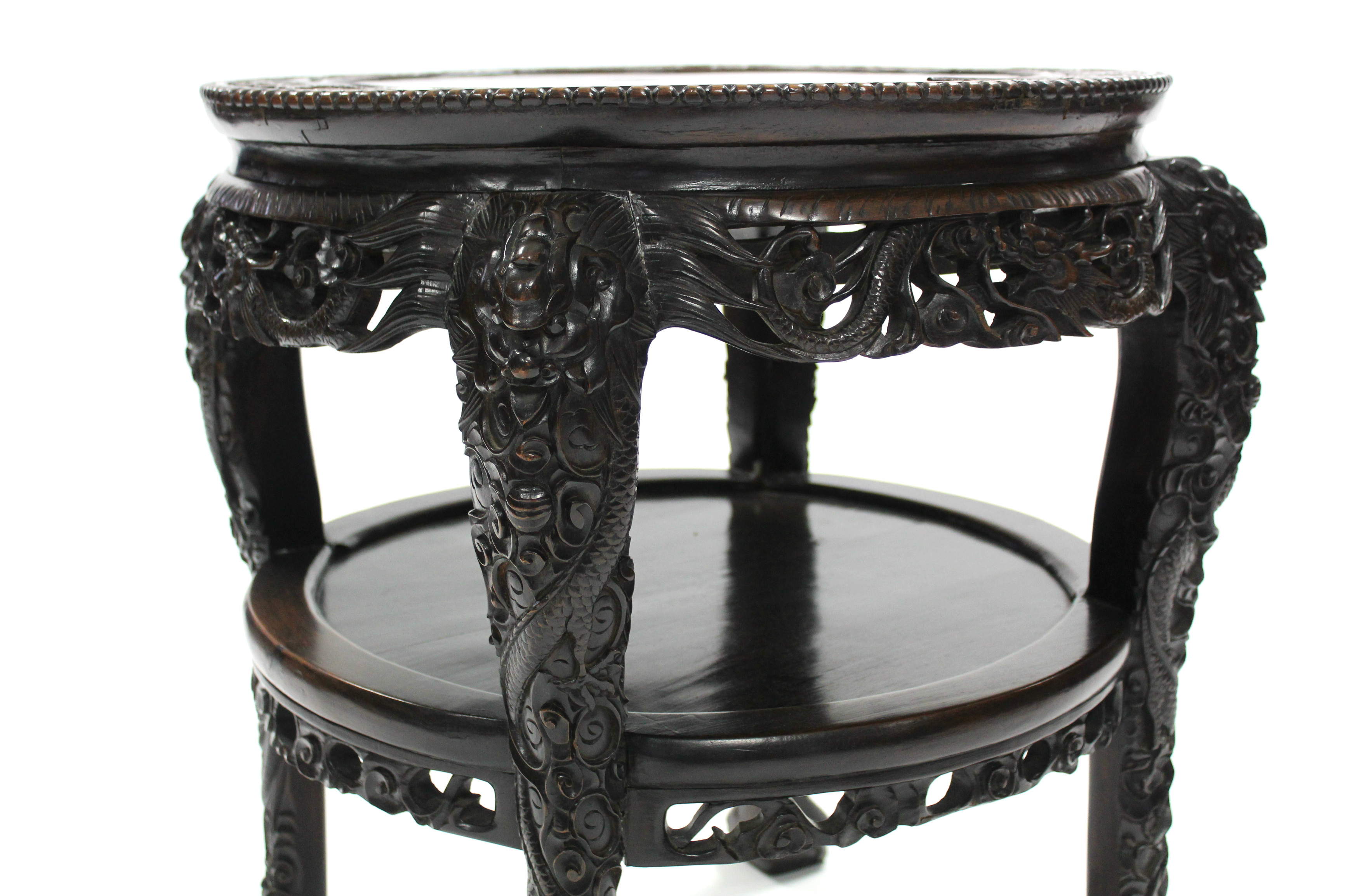 A late 19th century Chinese hardwood circular occasional table, profusely carved all-over with - Image 2 of 3