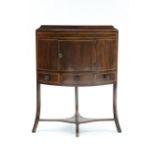 An early 19th century inlaid mahogany tray-top corner washstand, the cupboard enclosed by panel door