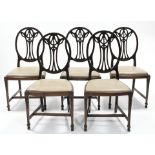 A set of six 19th century mahogany dining chairs, the oval backs with pierced husk-swag splats,