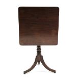 A regency mahogany tripod table, the rectangular tilt-top on slender ring-turned centre column &