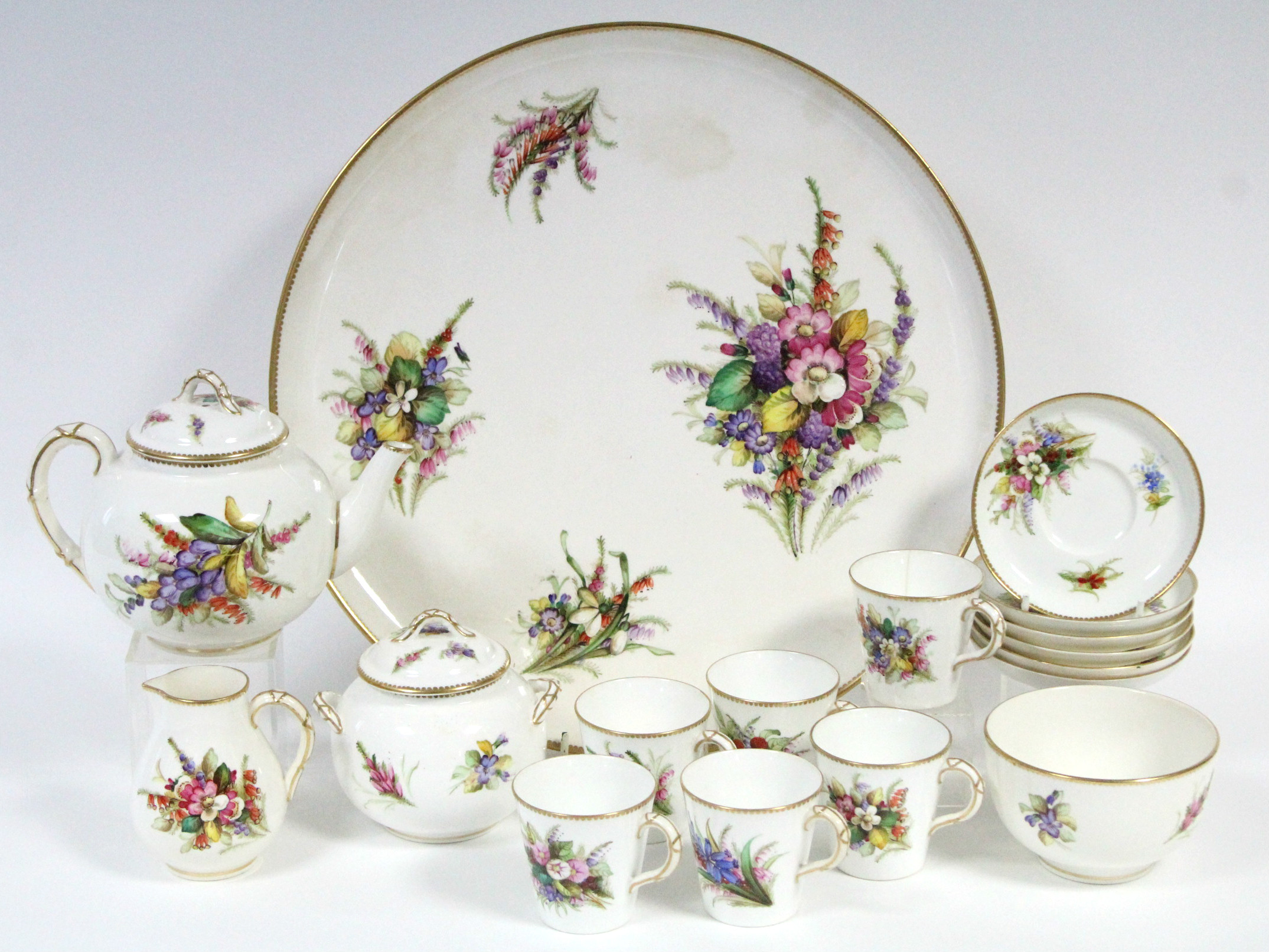 A ROYAL WORCESTER PORCELAIN TEA SERVICE with painted floral decoration on a white ground & with gilt