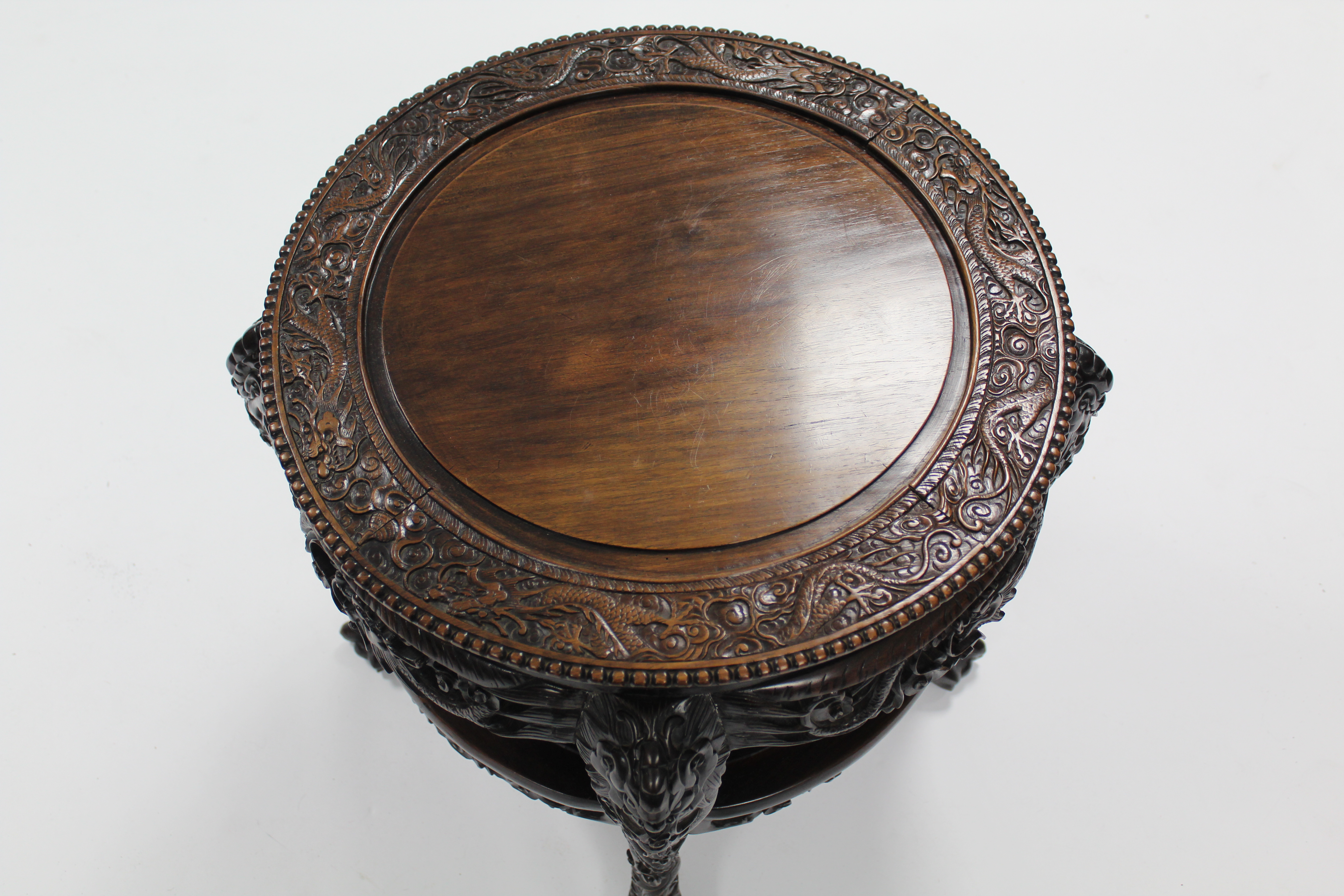 A late 19th century Chinese hardwood circular occasional table, profusely carved all-over with - Image 3 of 3