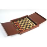 A late 19th century travelling ivory chess set of natural & red stain, height of Kings ½”, in