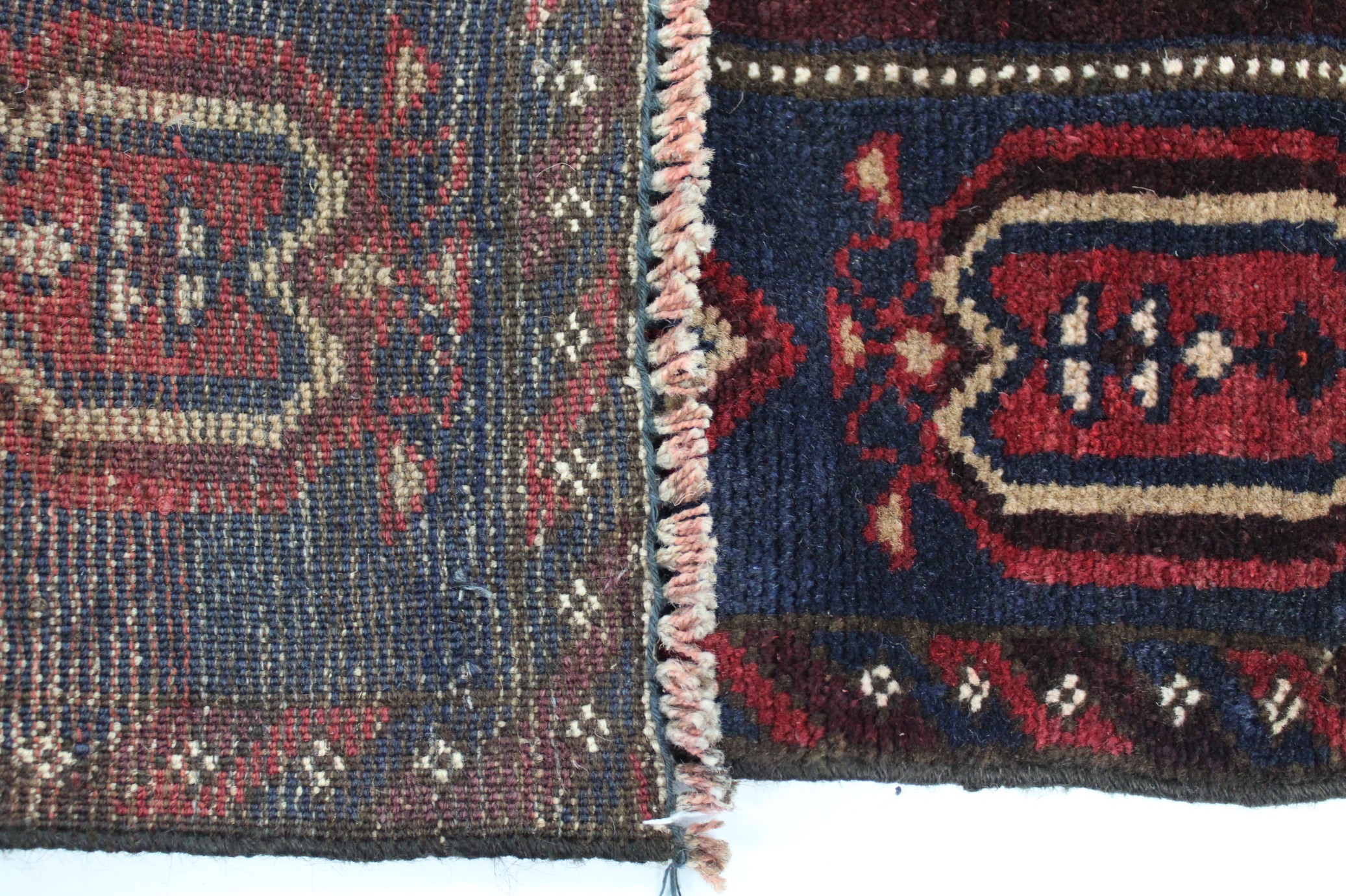 A Baluchi rug of crimson, ivory, & aubergine ground with central landscape design within a wide - Image 2 of 2