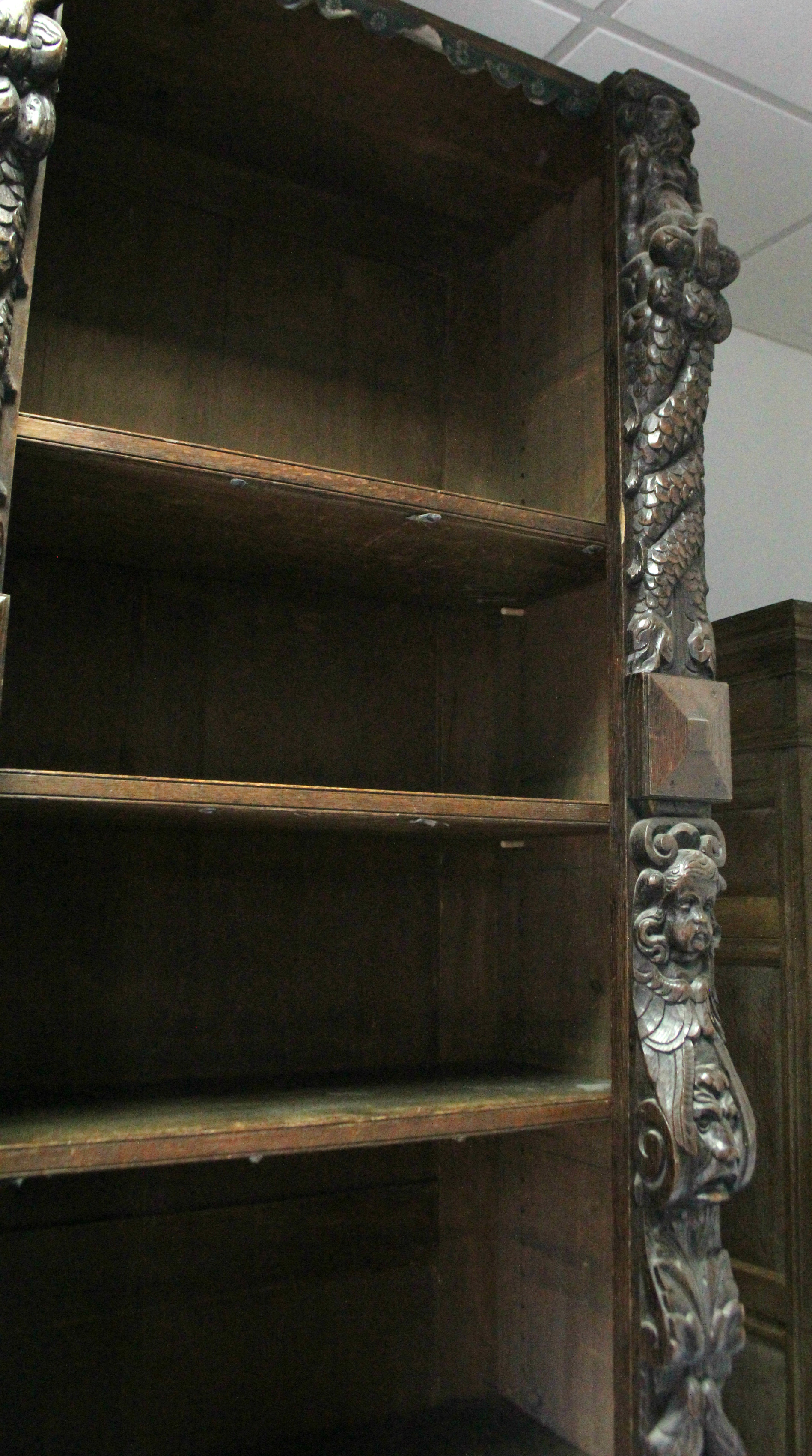 A Victorian oak tall standing open bookcase fitted fourteen adjustable shelves, and heavily carved - Image 4 of 7