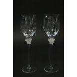 A pair of Rosenthal “Versace” wine glasses, each with opalescent figure-head to the stem; 11¾”