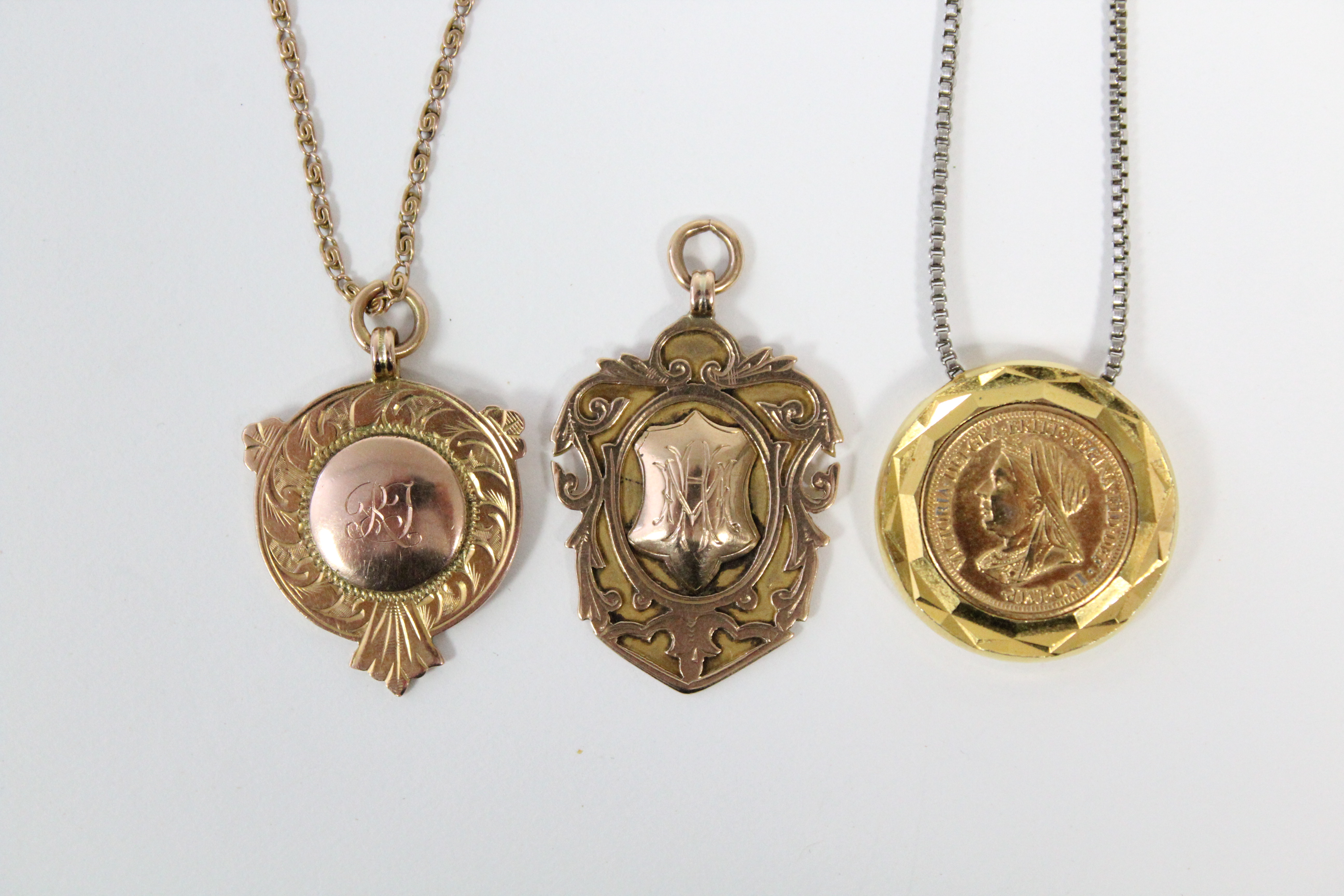 A yellow metal flat circular pendant inset facsimile Victorian half-sovereign; & two 9ct. gold