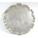 A George V silver circular salver with raised pie-crust edge, engraved inscription to the