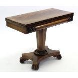 A William IV mahogany tea table, the rectangular fold-over top with carved frieze, on octagonal