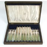 A set of six pairs of George V silver dessert knives & forks with onyx block handles; Sheffield 1919