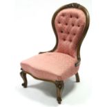 A Victorian carved mahogany frame nursing chair, the shaped buttoned-back & padded seat