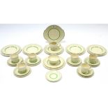 A Clarice Cliff thirty-four piece part dinner & tea service of cream ground & with green & gold