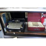 A Marconiphone portable radio in crimson fibre-covered case; together with two portable typewriters;