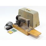 A Singer electric sewing machine, with case, w.o.