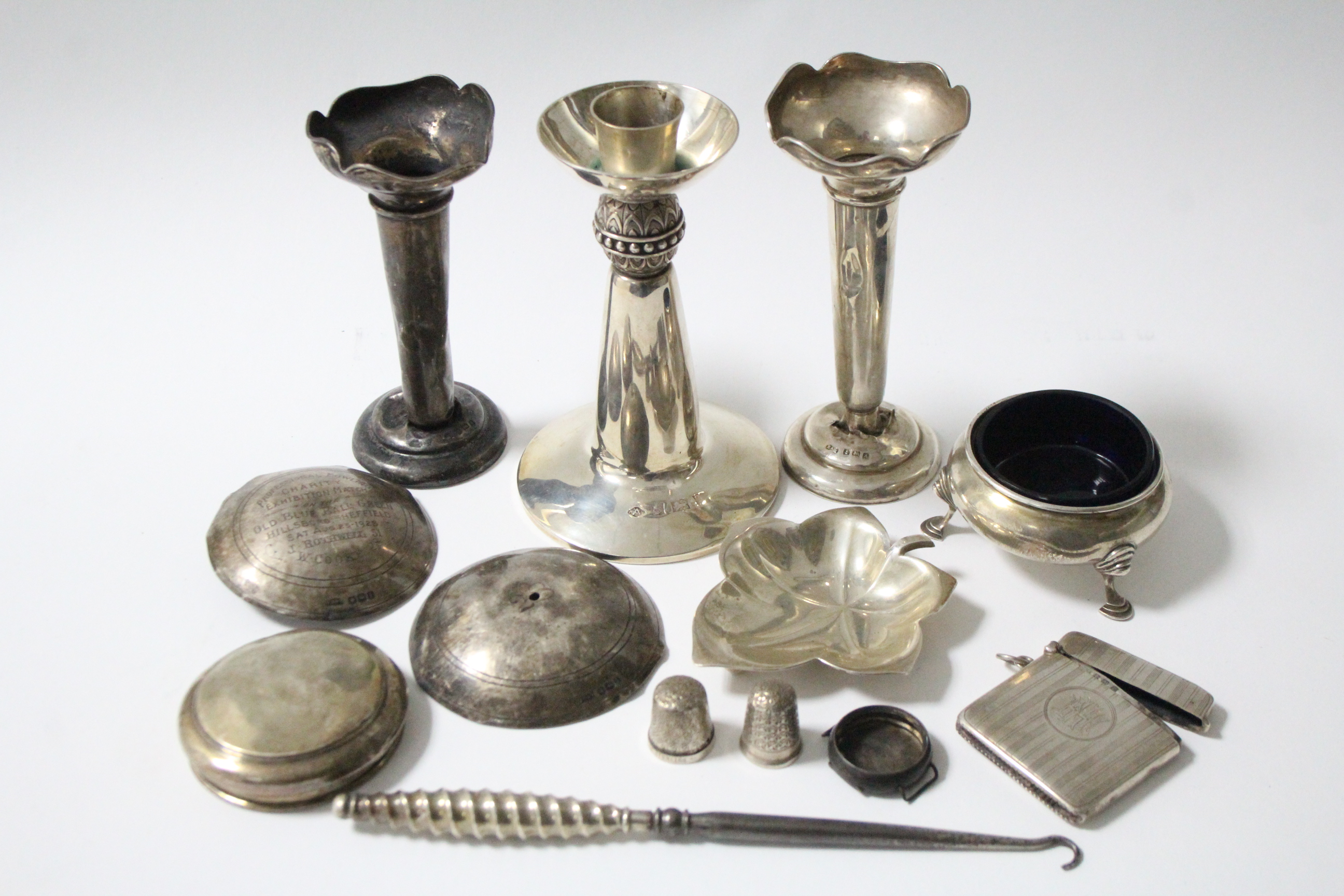 A silver candlestick in the art nouveau style, 4¾" high (hallmarks rubbed); a George V silver