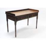 A Victorian mahogany tray-top side table fitted two frieze drawers, & on ring-turned tapered legs,