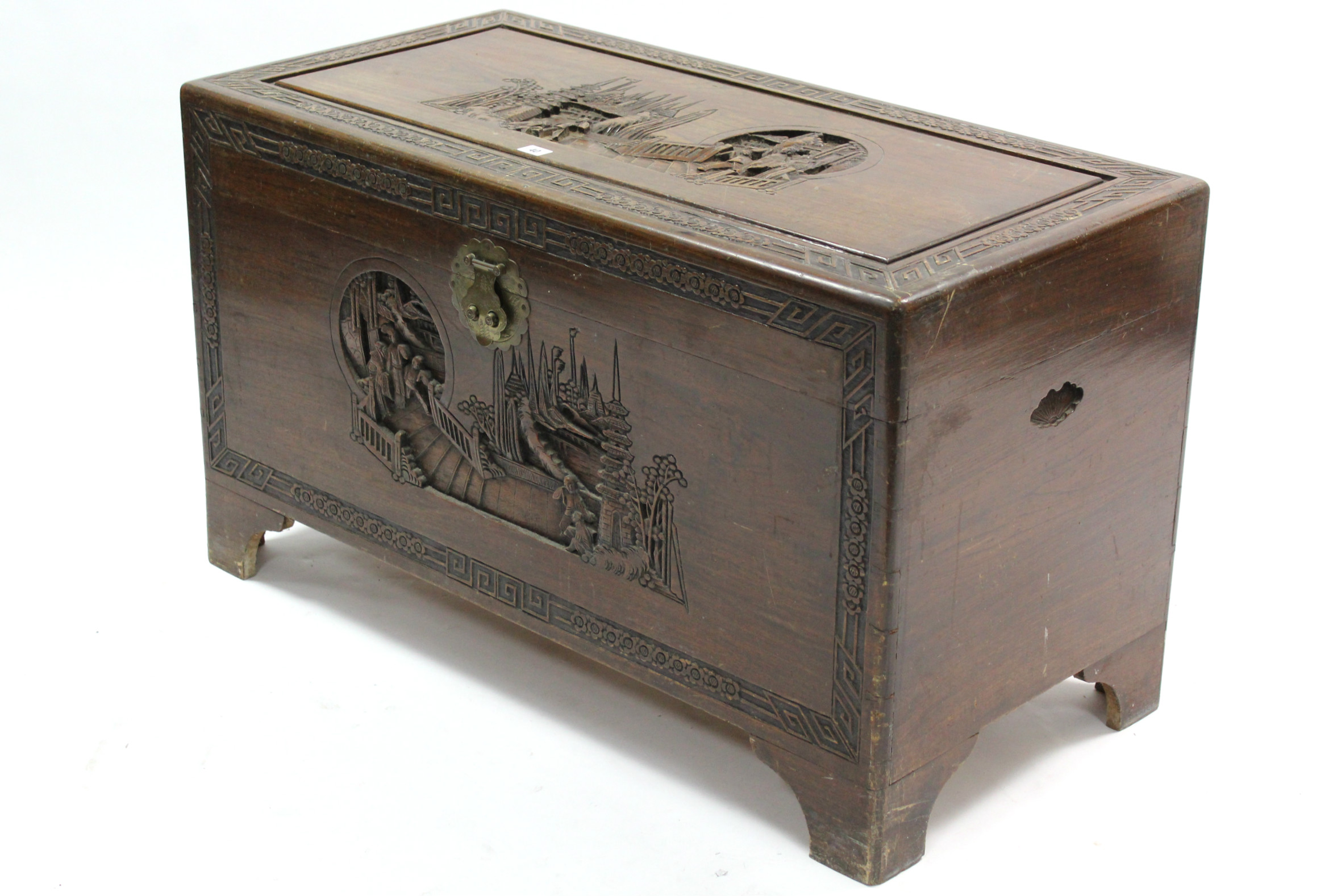 A Hong Kong carved camphor wood coffer with figure scene decoration to the hinged lift-lid &