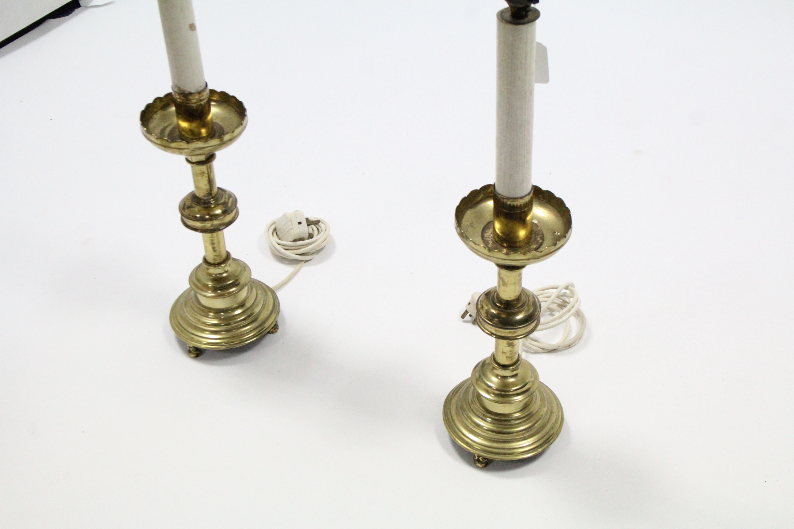 A pair of brass candle stands with lobed drip-pans, on round columns & circular bases with short - Image 3 of 3