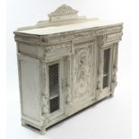 A continental white painted carved oak sideboard, 55" long; a matching set of six dining chairs (