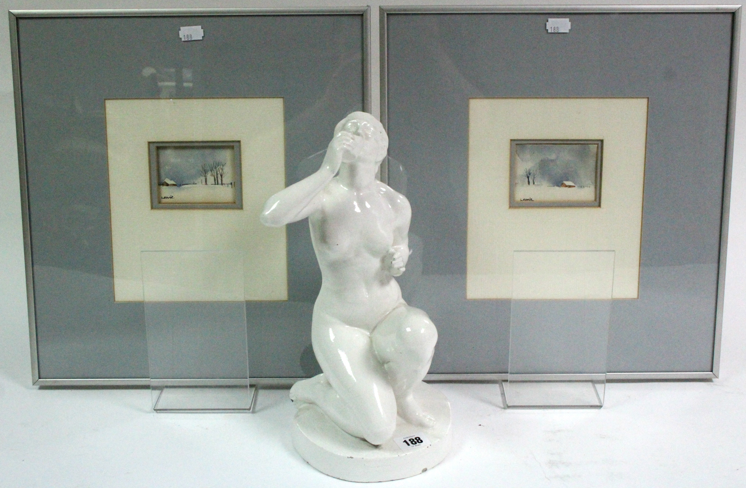 A white glazed pottery nude female figure, 13" high; & four decorative pictures, each in glazed