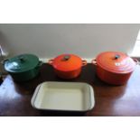 Two Le Creuset orange enamelled cooking pots, & a green glazed ditto.