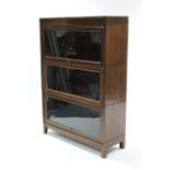 A mid-20th century oak three-tier sectional bookcase, each tier enclosed by glazed door, 34¼" wide x