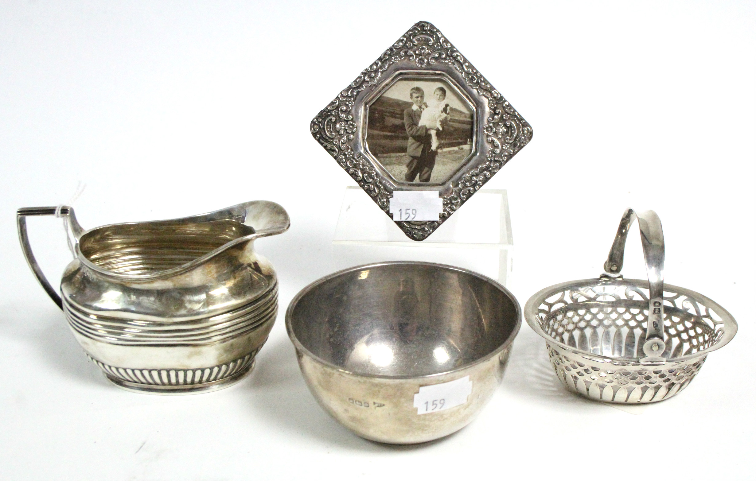 An Edwardian silver cream jug, 3¼" high, Sheffield 1903; a George V silver sugar bowl, 3 ¾" diameter