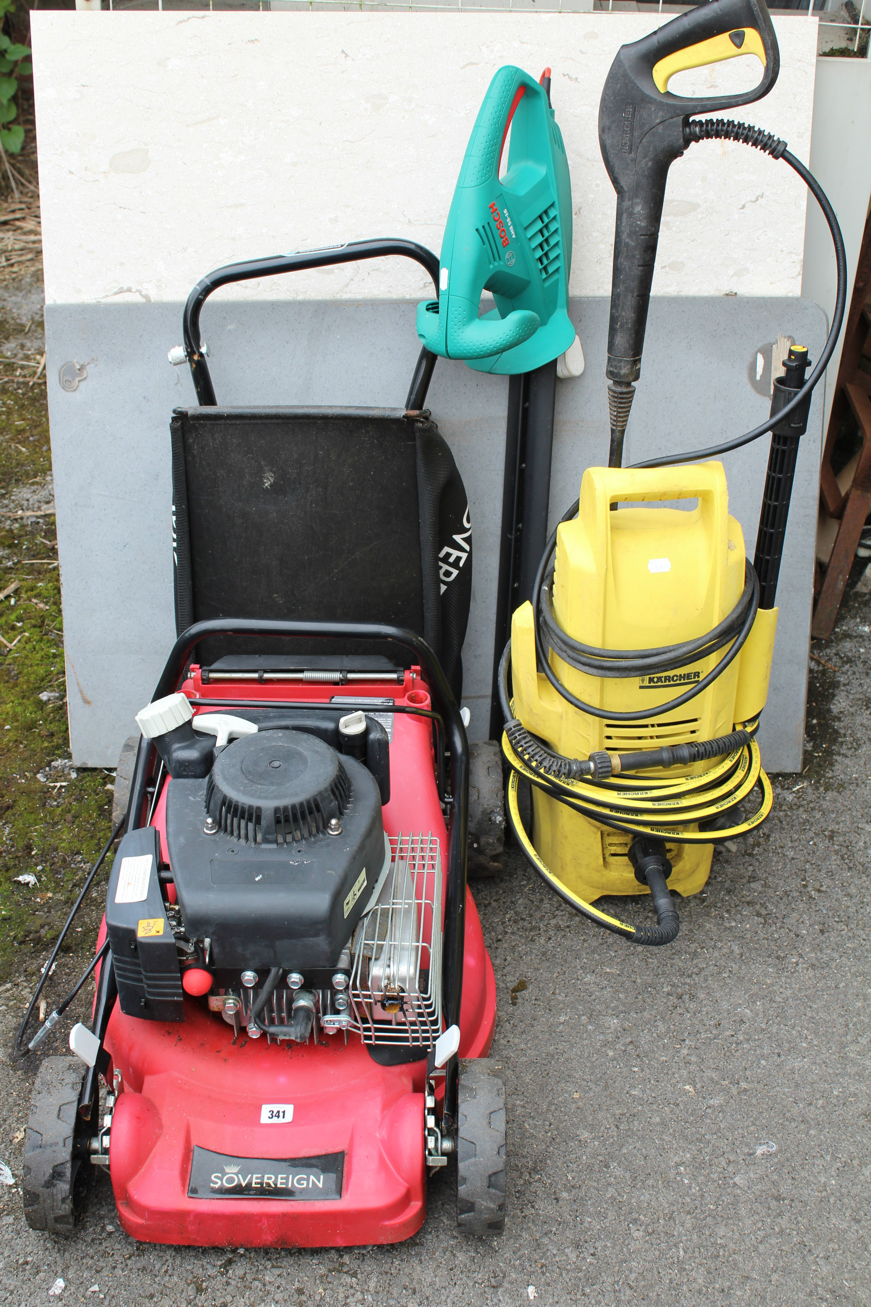 A Sovereign petrol-driven lawn mower; a Bosch electric hedge cutter; & a Karcher power washer.