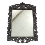 A 19th century rectangular wall mirror in carved oak scroll frame, 38½" x 25½".