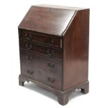 A George III mahogany small bureau, with fitted interior enclosed by fall-front above four long