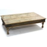 An Indian teak large rectangular low coffee table with carved frieze, & on short turned legs, 60"