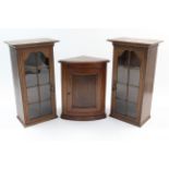 A pair of small oak bookcases, each enclosed by glazed door, 17¾" wide x 33" high; & a small