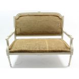 A French white painted & carved wooden frame two-seater sofa (requires upholstery), on fluted &