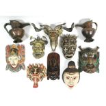 A pair of Tibetan copper jugs, 8¾" high; eight various oriental & African masks; & various items