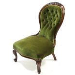 A Victorian carved walnut frame nursing chair, with buttoned back & sprung seat upholstered green
