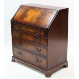A reproduction inlaid-mahogany small bureau, with fitted interior enclosed by fall-front above