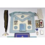 Two silver & enamelled masonic regalia medals; two plain silver ditto; a masonic regalia apron; &