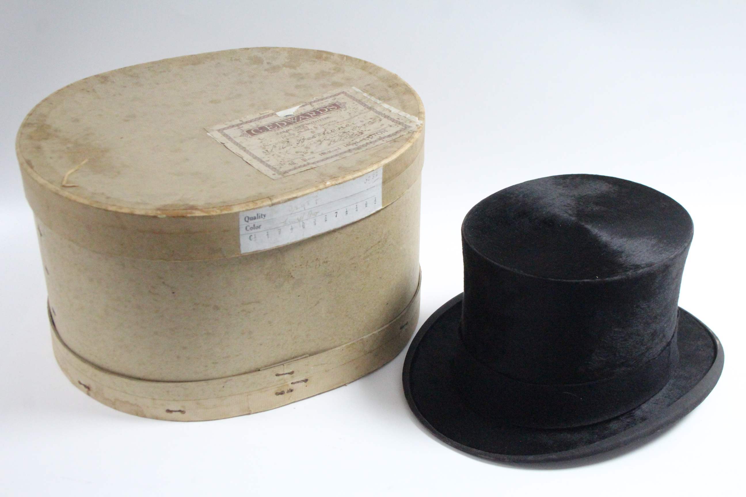 A Linney of London black silk top hat; with a contemporary oval cardboard hat box. Provenance: The