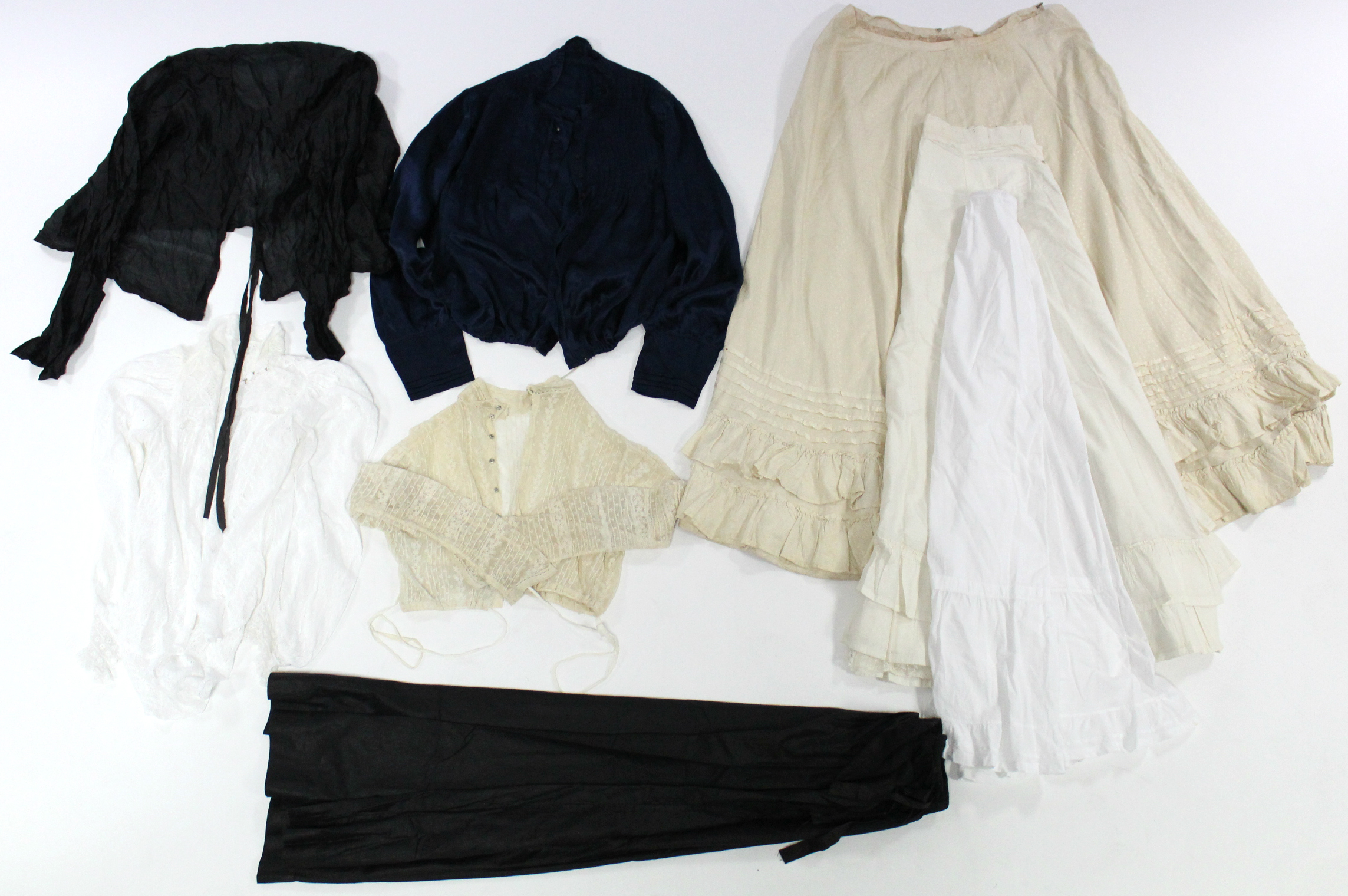 An early 20th century navy silk blouse; a black Jap silk ditto; two lace ditto; a cream figured silk