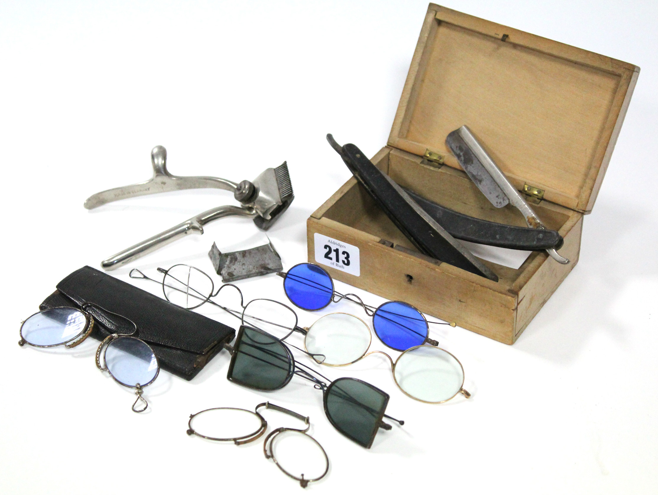 A pair of late 19th/early 20th century steel-frame spectacles with blue-tinted lenses having
