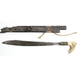 A Borneon ceremonial knife with 18½” long single-edge curved blade, with carved bone handle, &