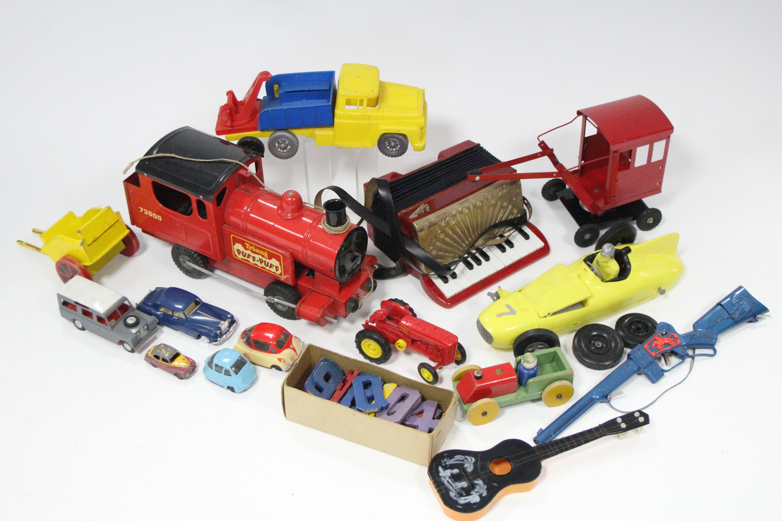 A Tri-ang pull-along “Puff-Puff” train; a child’s piano accordion; five mode cars, etc.