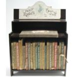 Twenty-four various Beatrix Potter children’s books, displayed in a “Peter Rabbit’s Book Shelf”, 11”